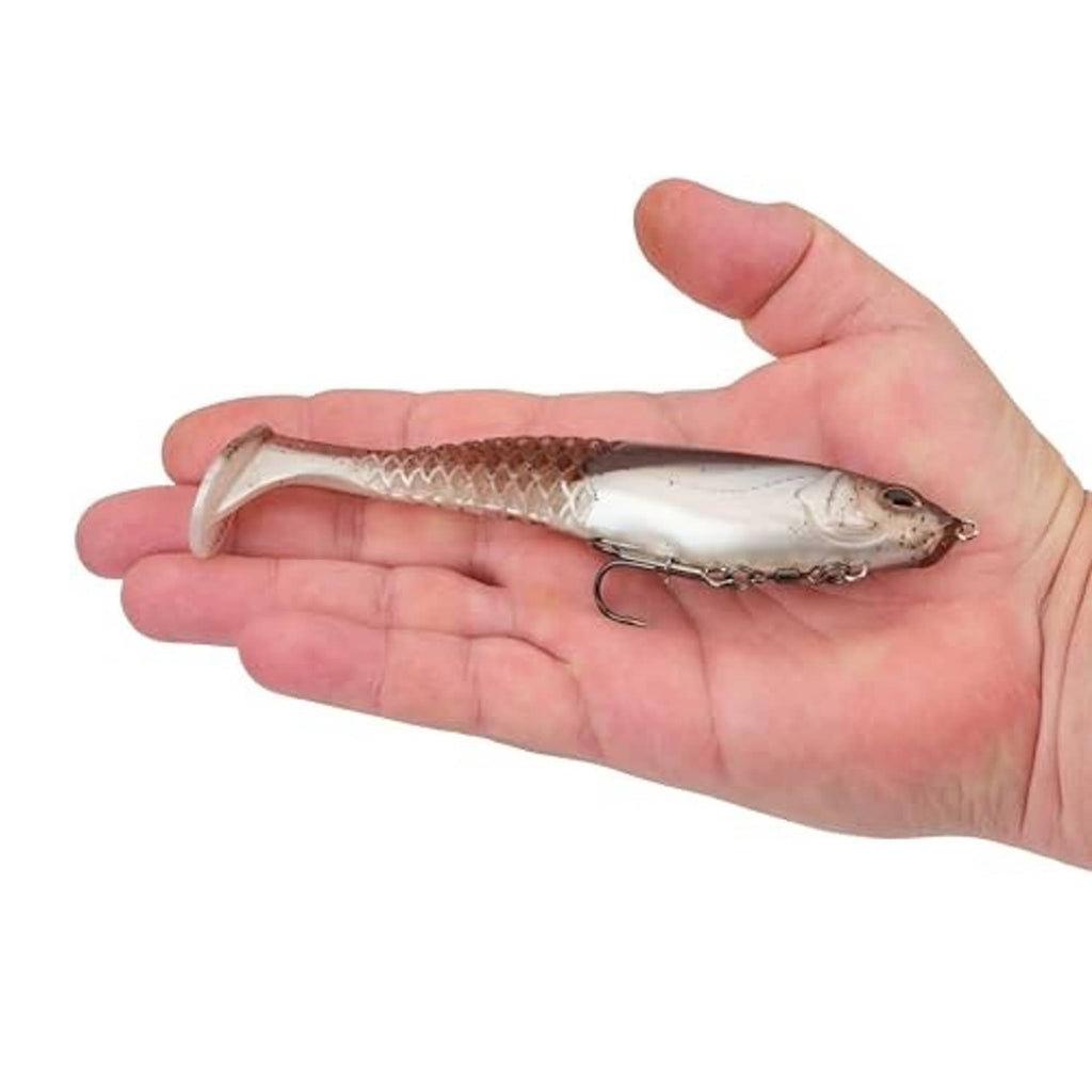 Soft plastic swim bait green-pumpkin pearl held in hand, with treble hook