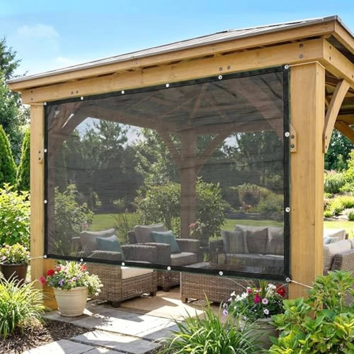 Black pergola shade cloth with metal grommets, covering outdoor seating area