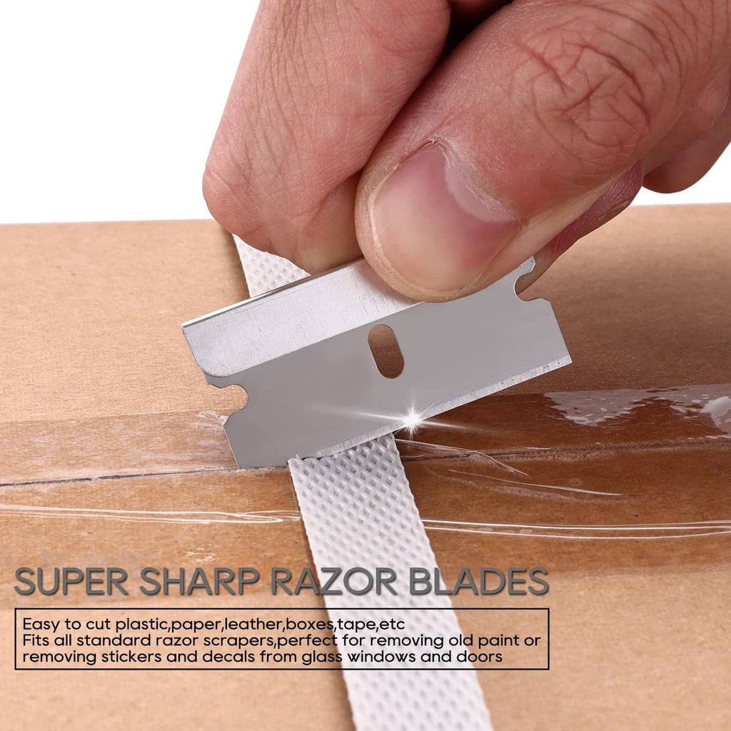 Single-edge razor blade scraping surface; blade held in hand