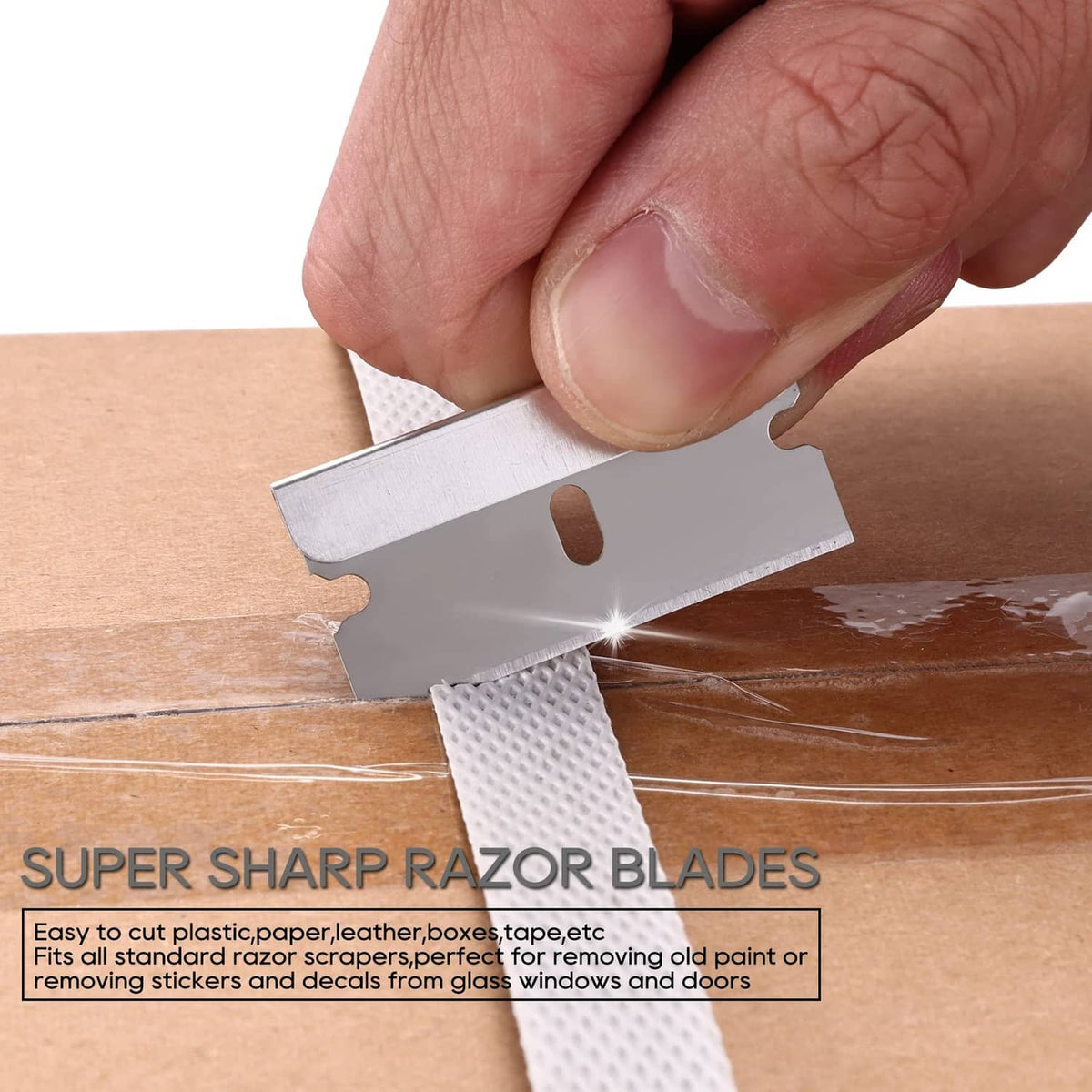 Single-edge razor blade scraping surface; blade held in hand
