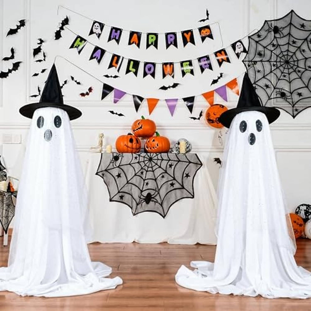 Two standing ghost decorations with black hats, dotted faces, and white draped sheer fabric for Halloween.
