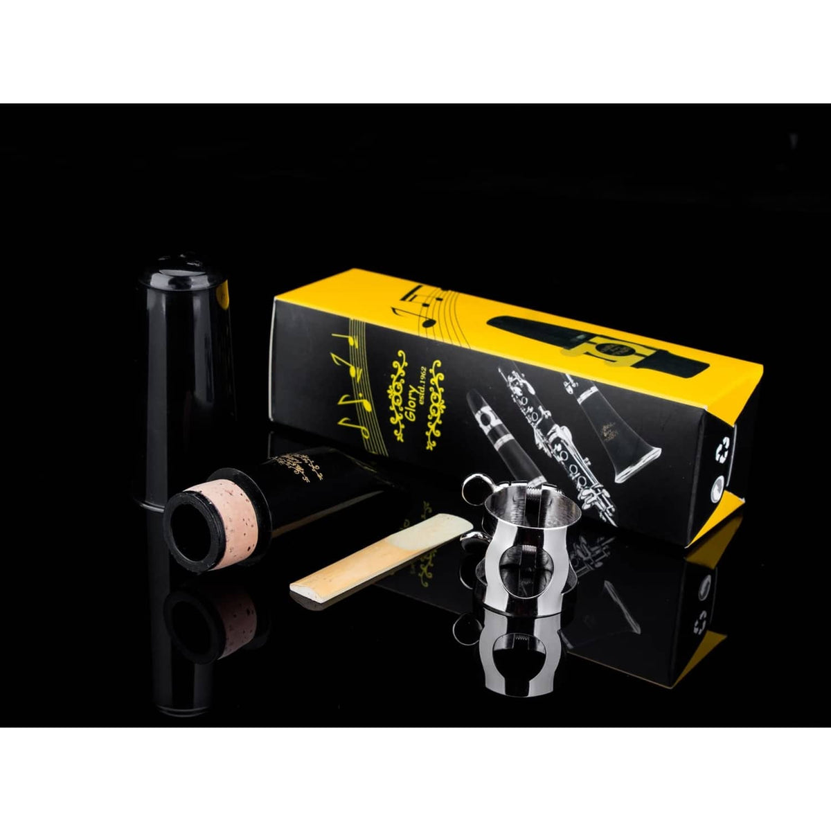 Clarinet mouthpiece kit with black mouthpiece, cork reed, silver ligature, and yellow box