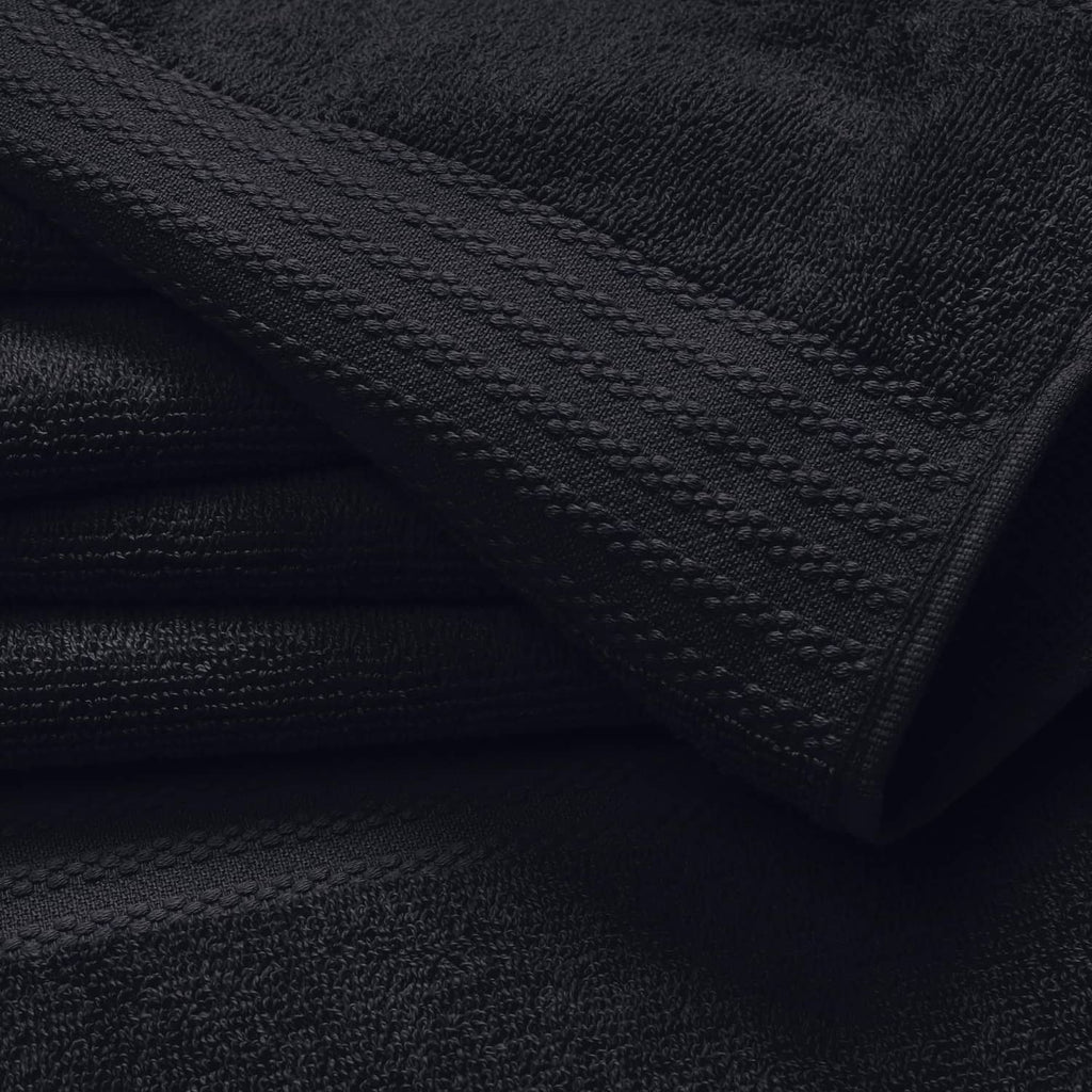 Black hand towel close-up with stitched border and textured looped fabric