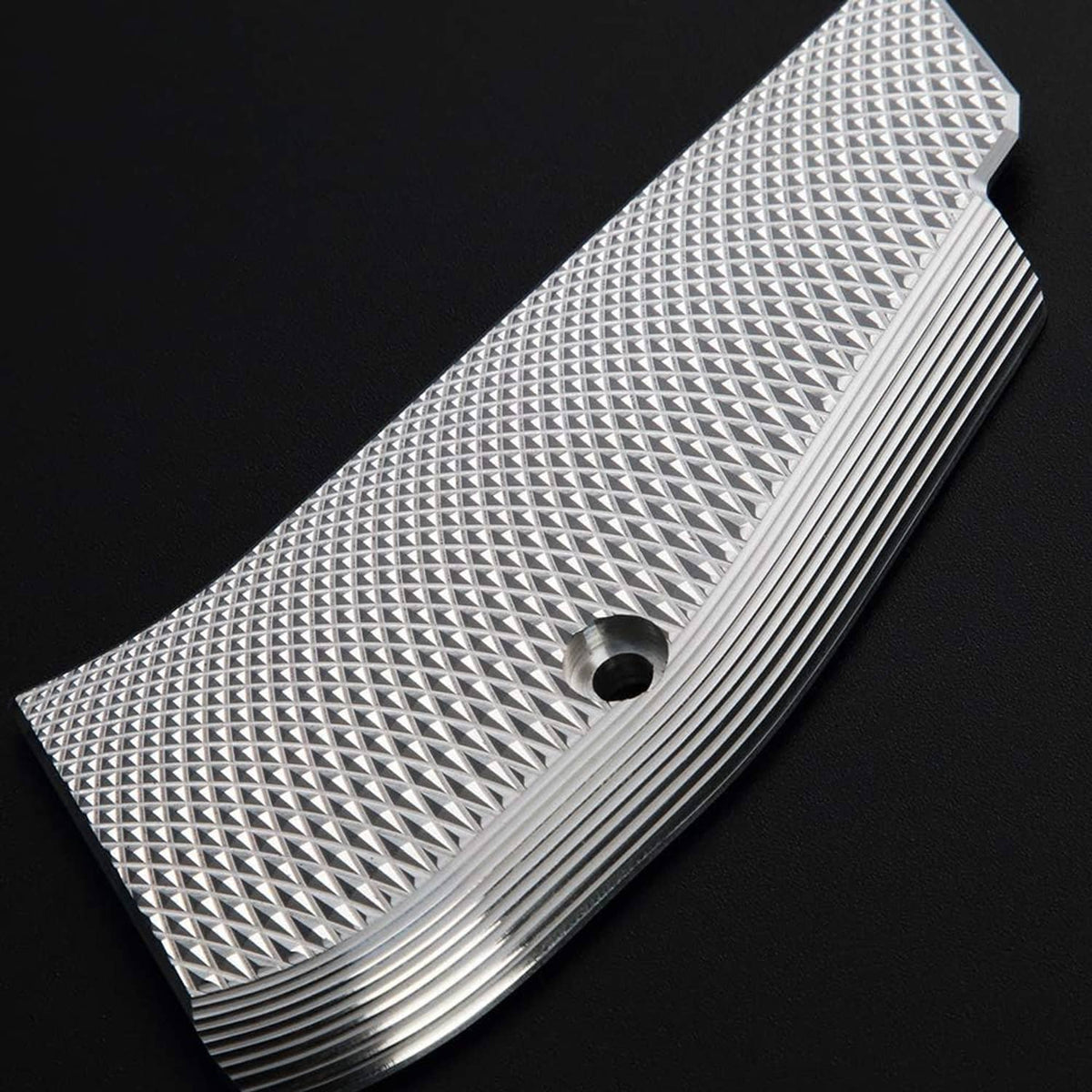 Single aluminum grip panel with diamond checkered surface and ribbed lower edge