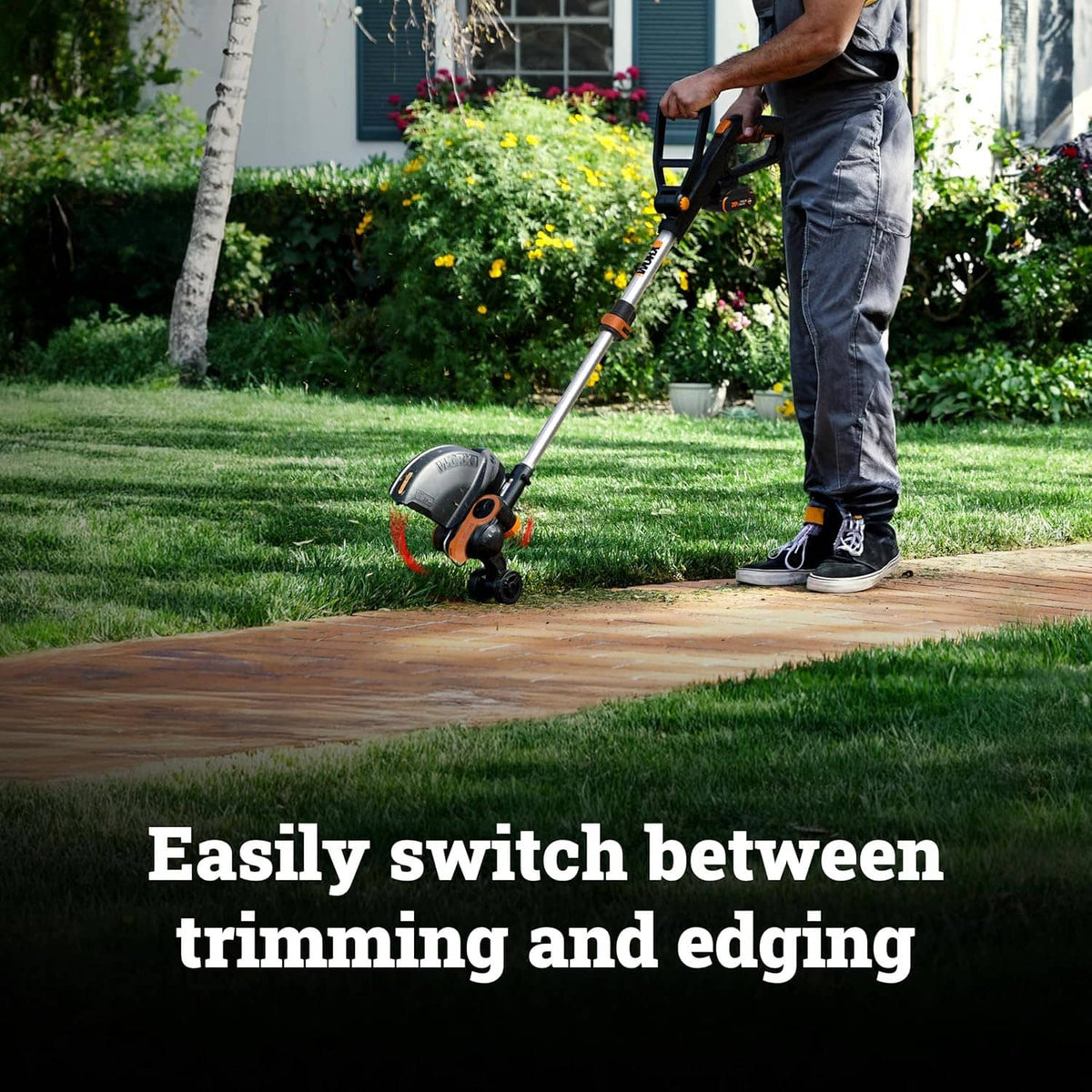 Cordless string trimmer in use on a lawn edge with operator holding the handle