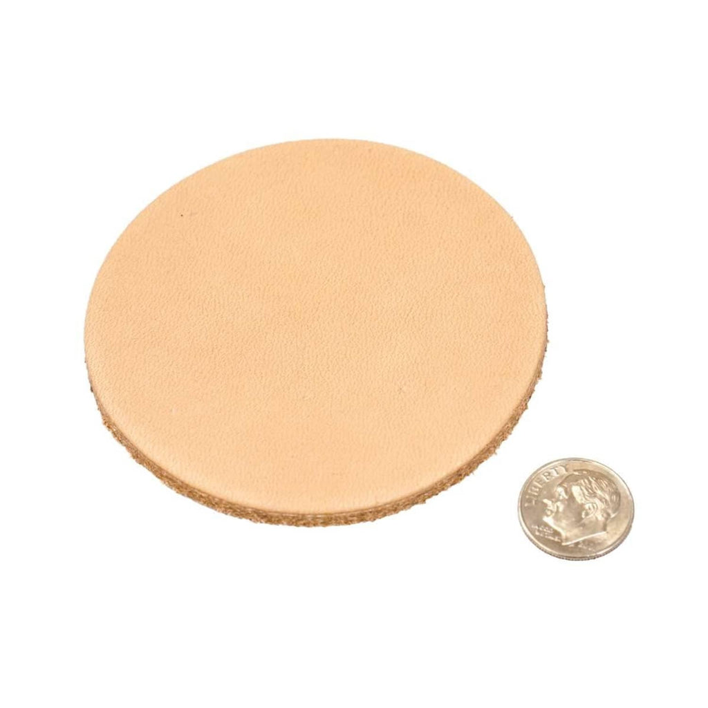 Round vegetable-tan leather disc, light tan, shown with a small coin for scale