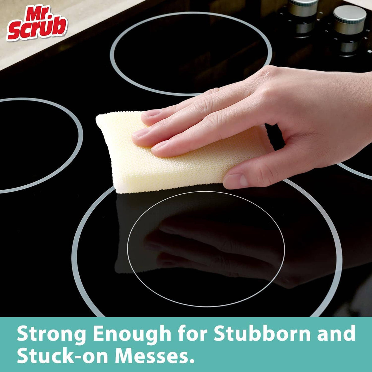 Hand holds a pale yellow non-scratch sponge on a stovetop