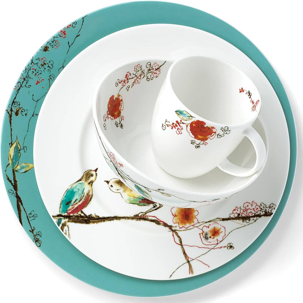 Top view of white bird-and-floral ceramic bowl and cup with a teal-rim plate