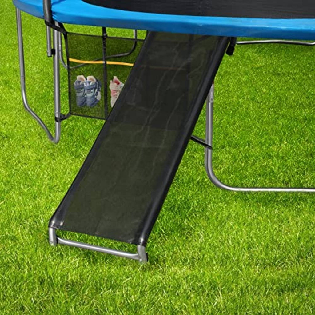 Outdoor trampoline slide ramp with black ladder and metal supports on grass