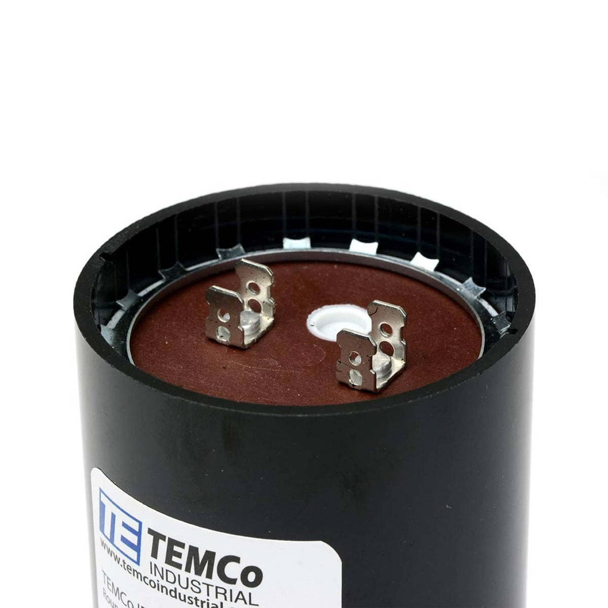 Close-up of black cylindrical start capacitor top with three metal terminals