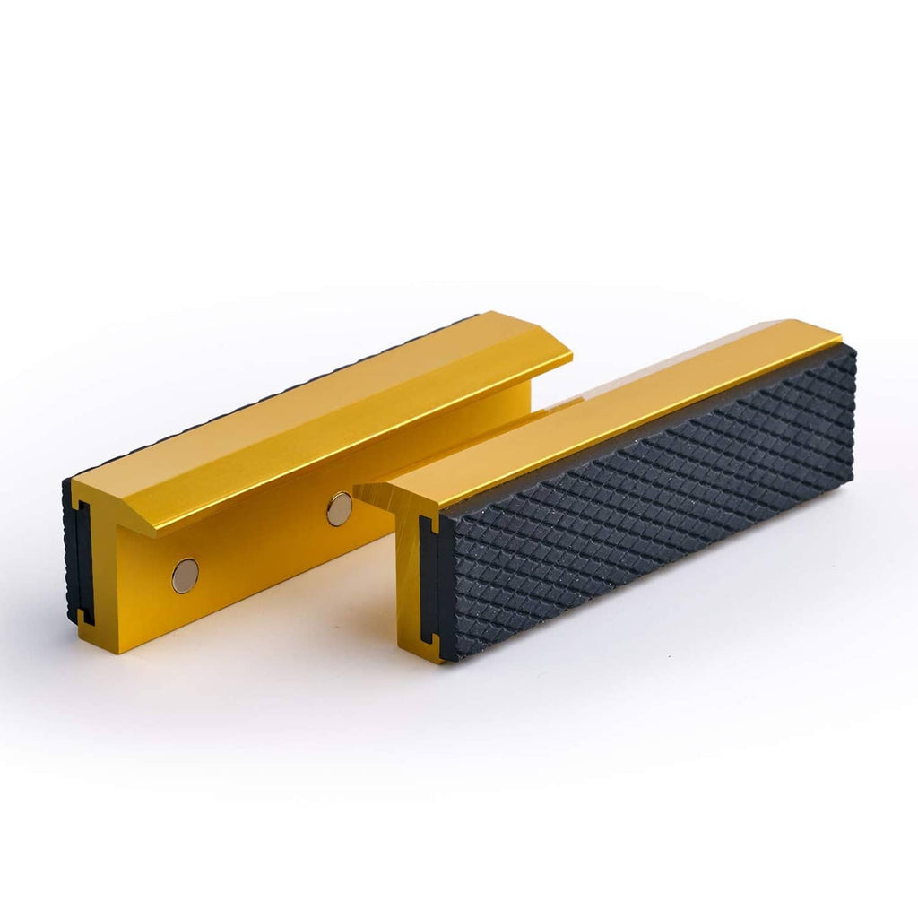 Pair of golden soft vise jaw covers with black textured pads for 4-inch vise jaws