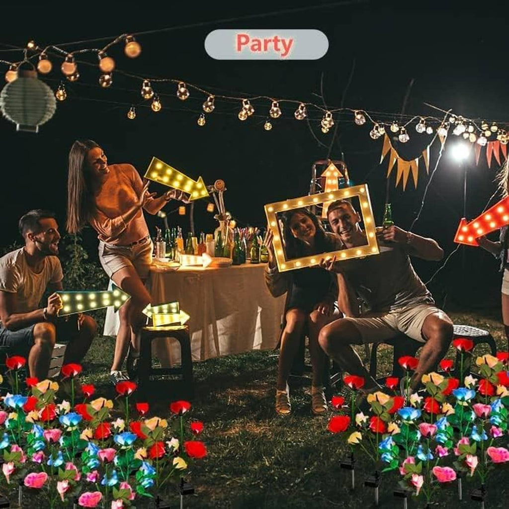 Solar rose garden lights with glowing red and blue blooms in an outdoor party scene