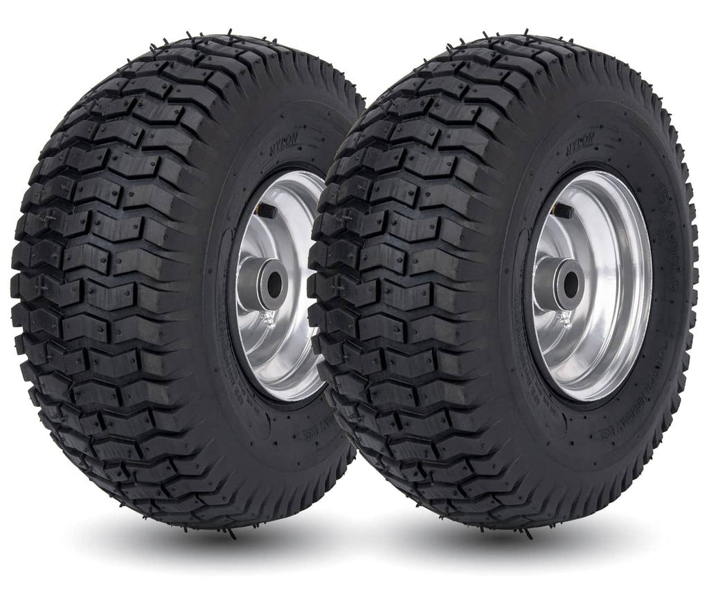 Pair of black lawn mower tires with silver wheel rims and deep tread pattern