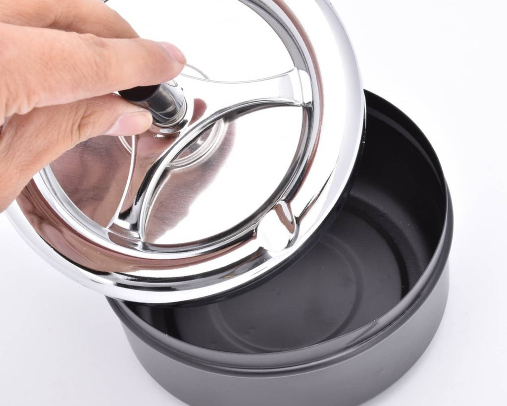 Close-up of chrome spinning tray top on a black round ashtray