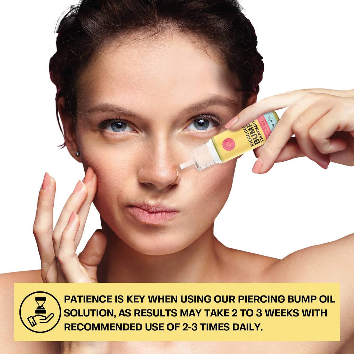 Piercing bump solution oil applied from a small squeeze tube near face.