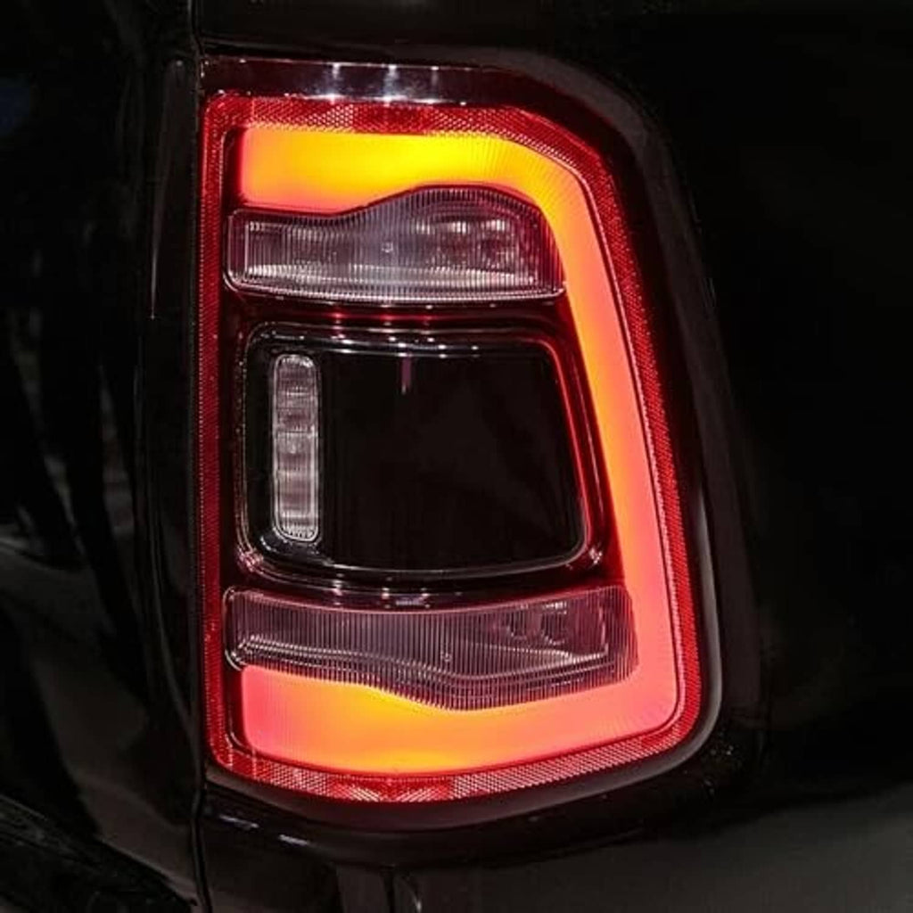 Illuminated tail light assembly with red outer lens and clear light elements