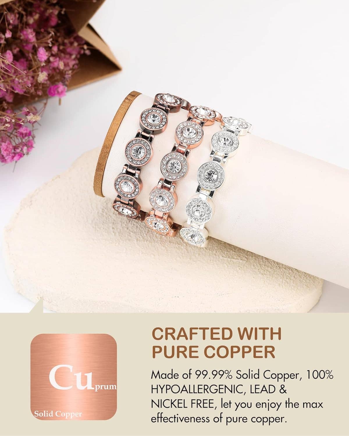 Rose gold copper magnetic bracelet with rhinestone oval links on a display pad
