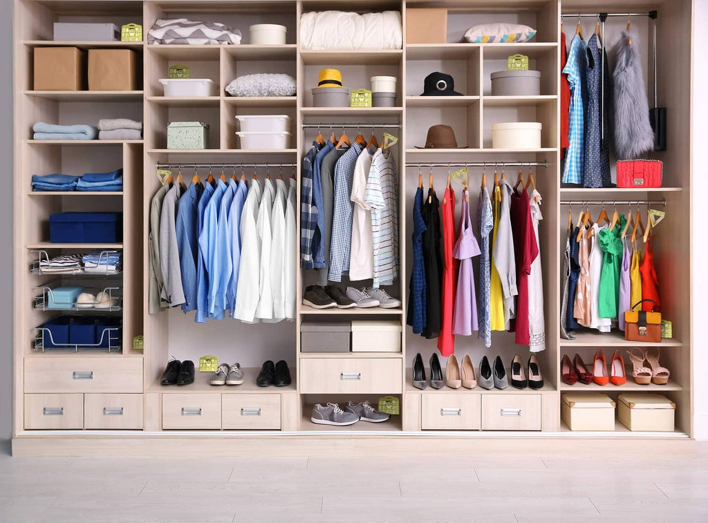 Closet organizer with hanging garments, shoes, and folded items on shelves