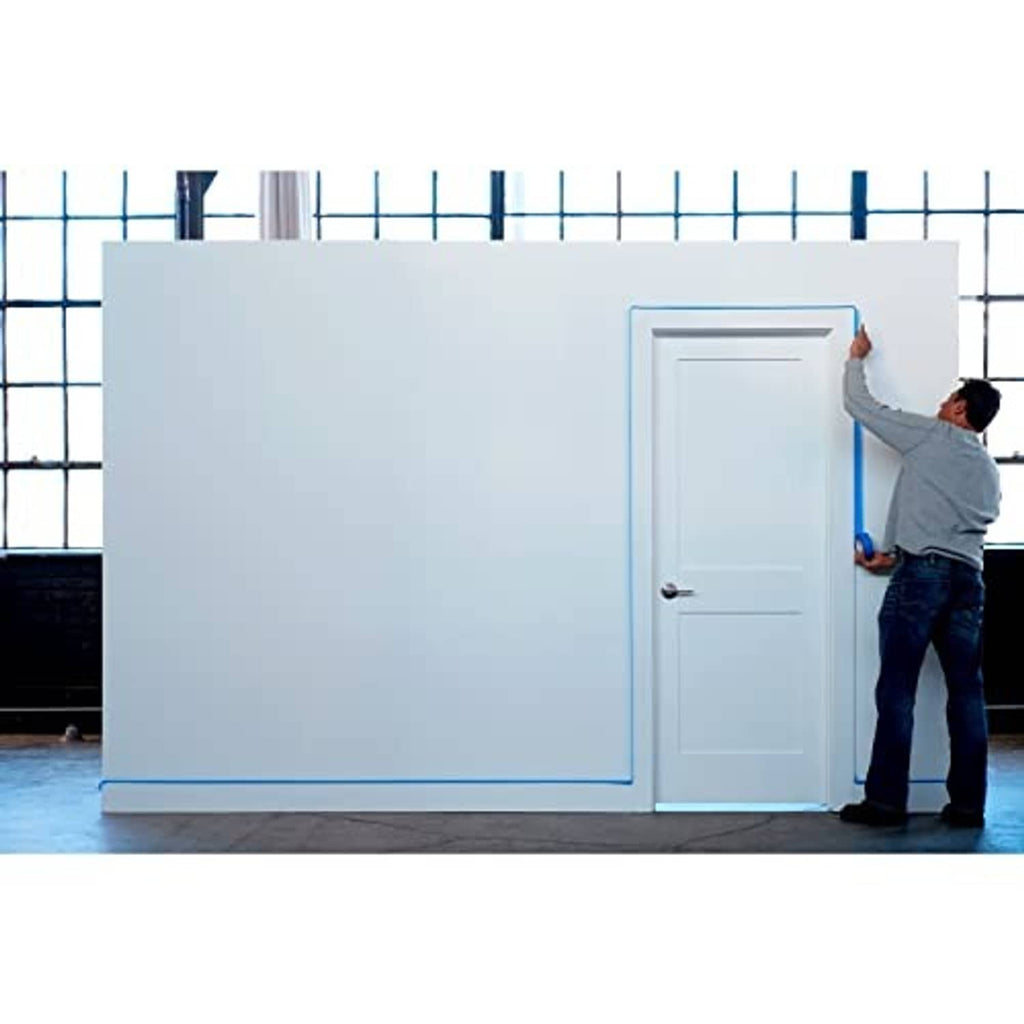 Blue painter's tape around a doorway and wall corner before painting