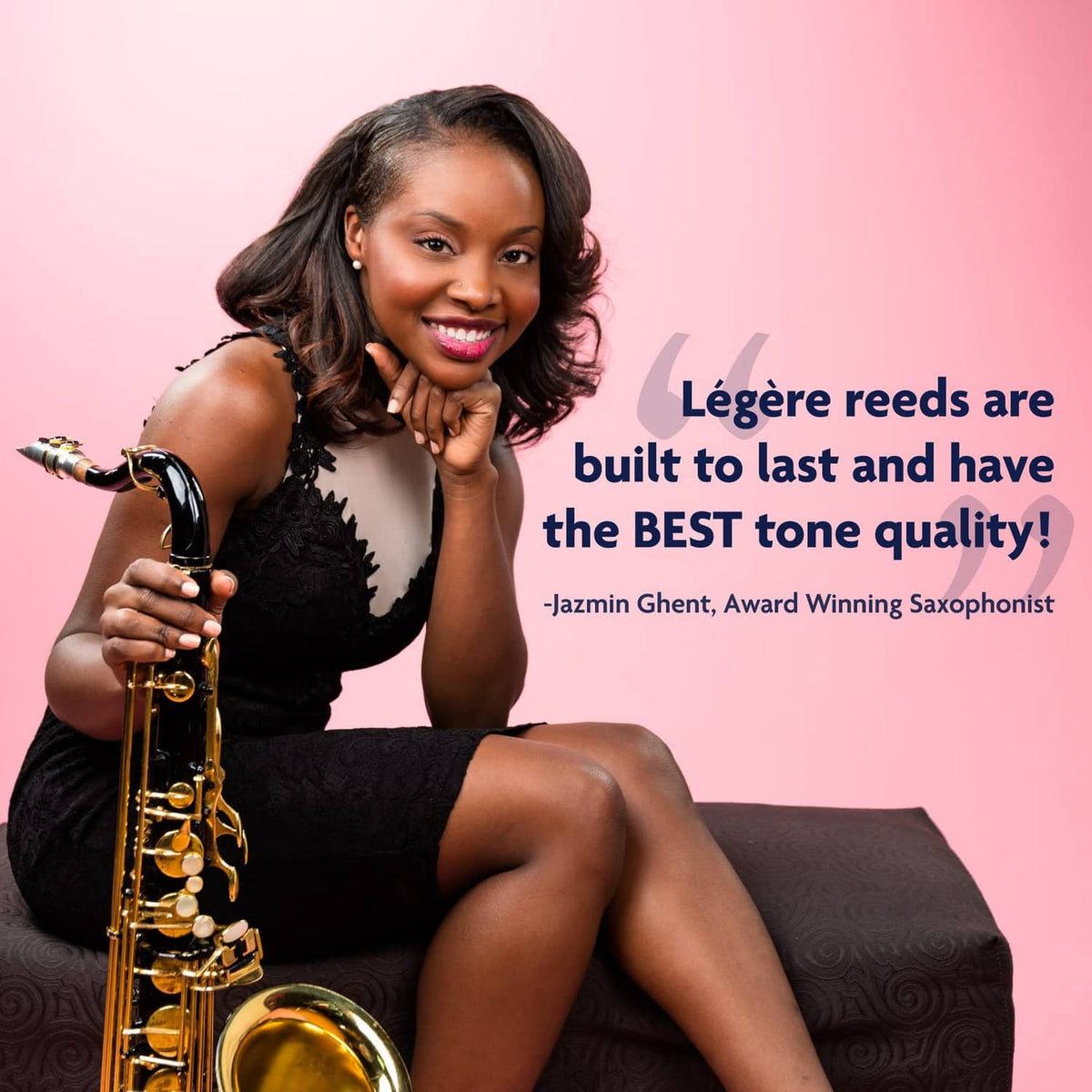 Saxophonist holding baritone sax with reed ready to play