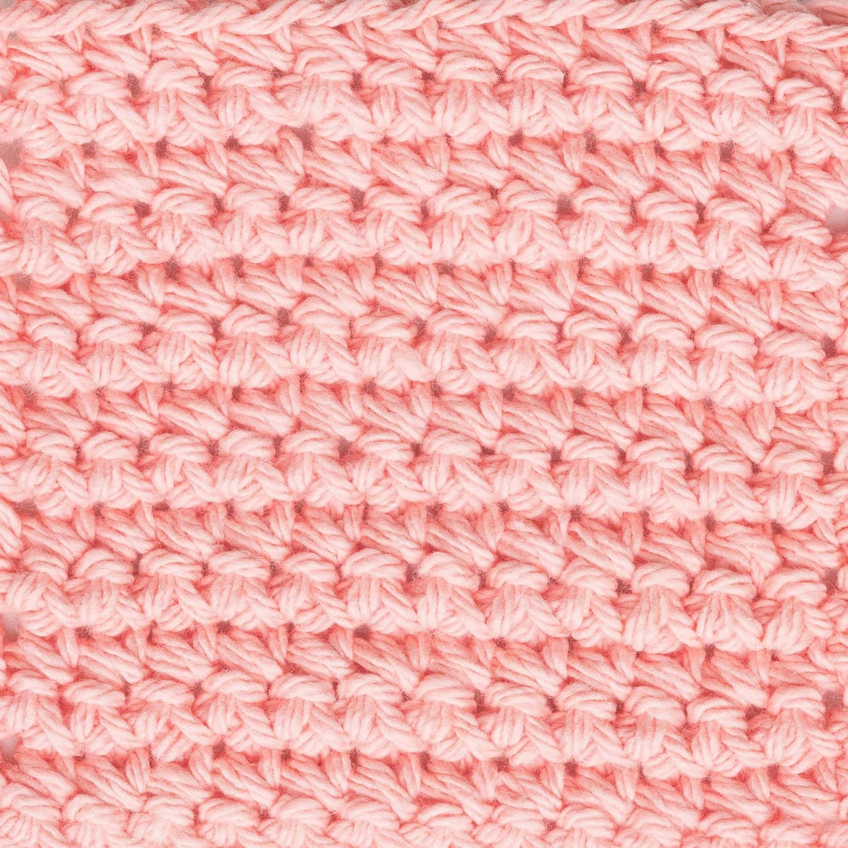 Light pink crochet stitch fabric swatch with repeating loop pattern
