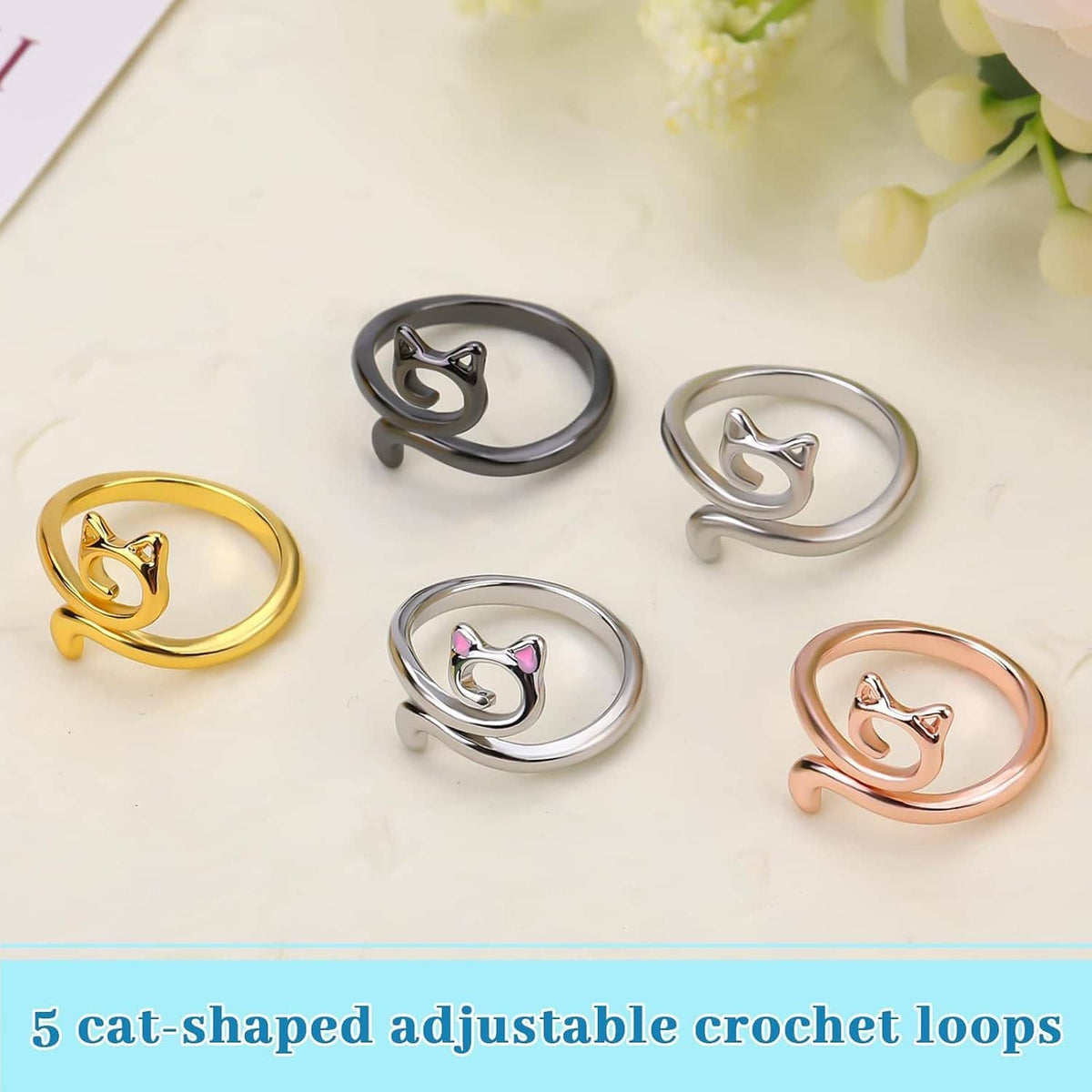 Five cat-shaped adjustable crochet tension rings in silver, gold, black, peach, and rose tones