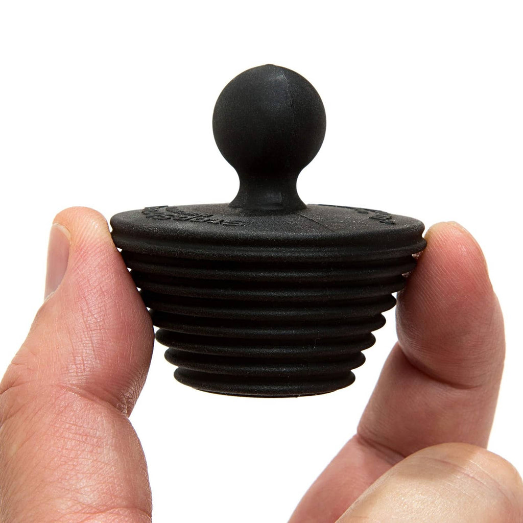 Black universal stopper plug held in hands, front view, two-pack