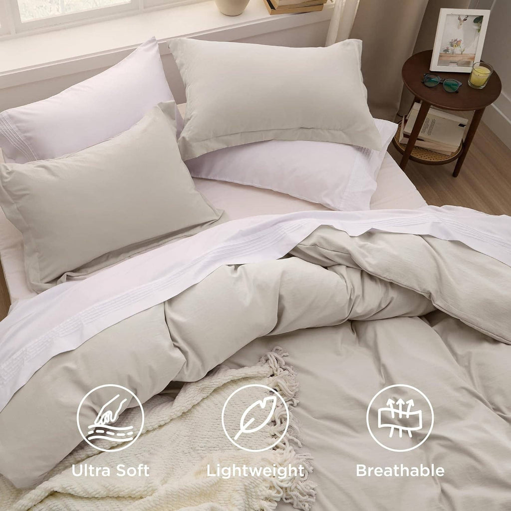 Light beige bedding set with duvet cover and multiple matching pillow shams