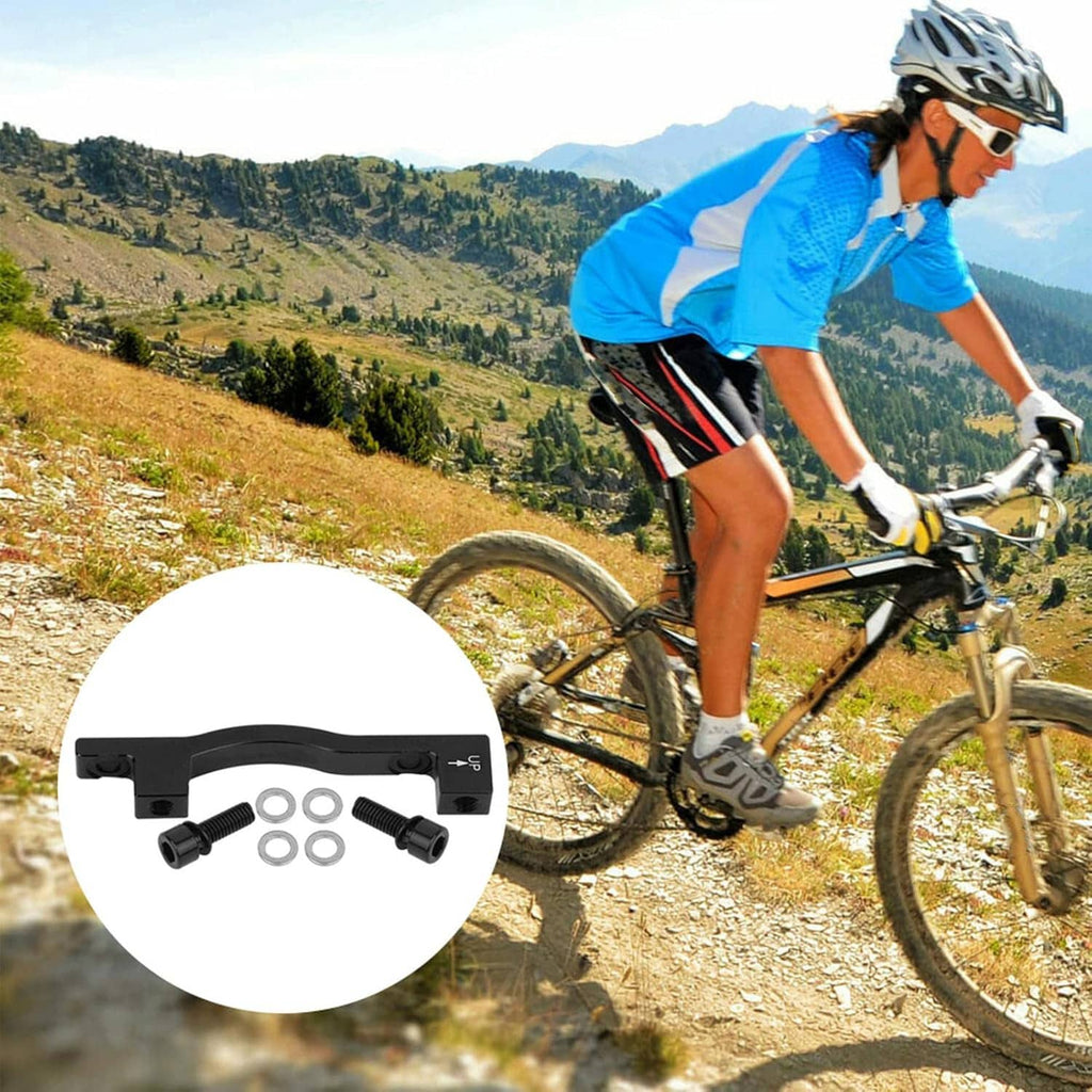 Bike disc brake spacer adapter kit with bracket, bolts, and washers in white display