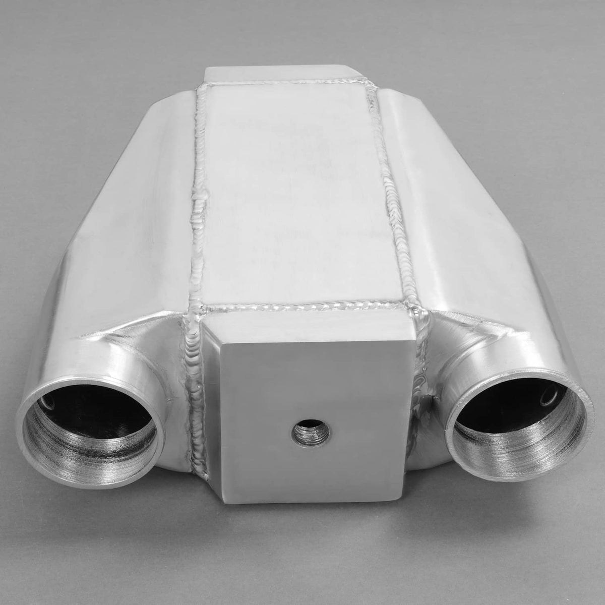 Universal air-to-water intercooler front view showing two round inlet ports and center hole