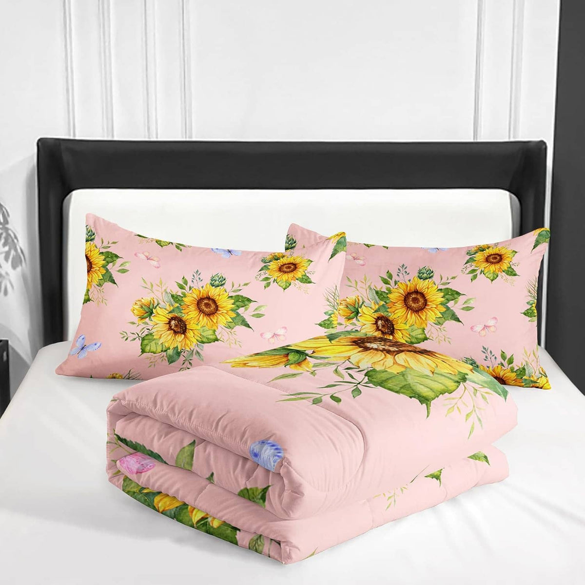 Folded pink sunflower comforter set with two floral pillow shams