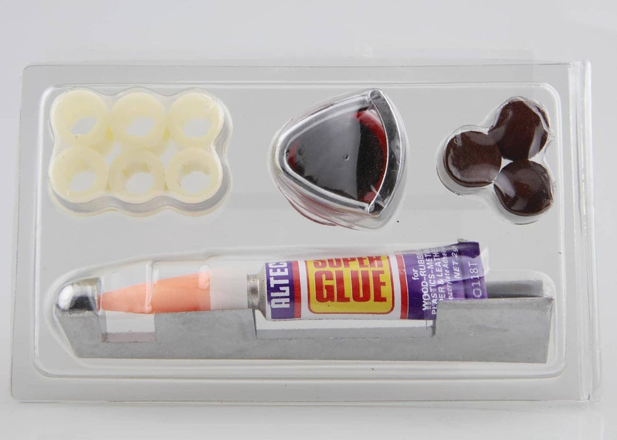 Cue tip repair kit in clear tray: pale tips, metal clamp, dark brown pieces, glue tube