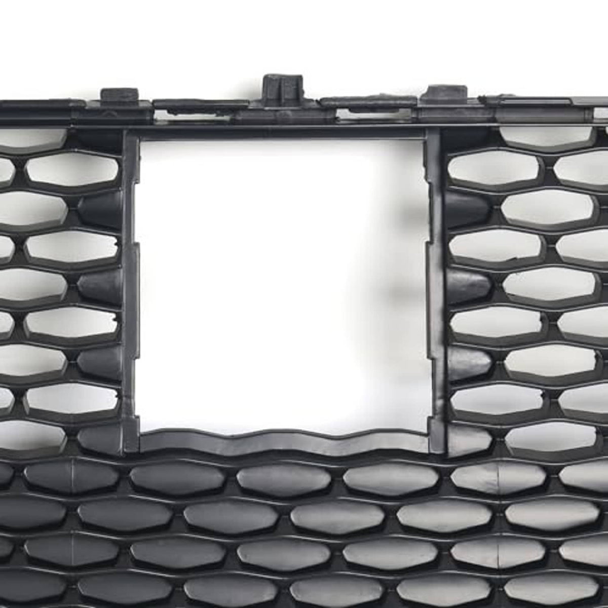Front grille insert with silver rectangle surround on black honeycomb mesh.