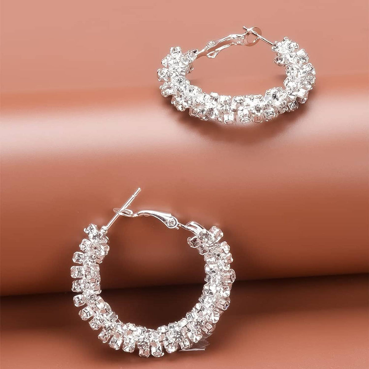Silver-toned small hoop earrings with sparkling stones and hinged clasps