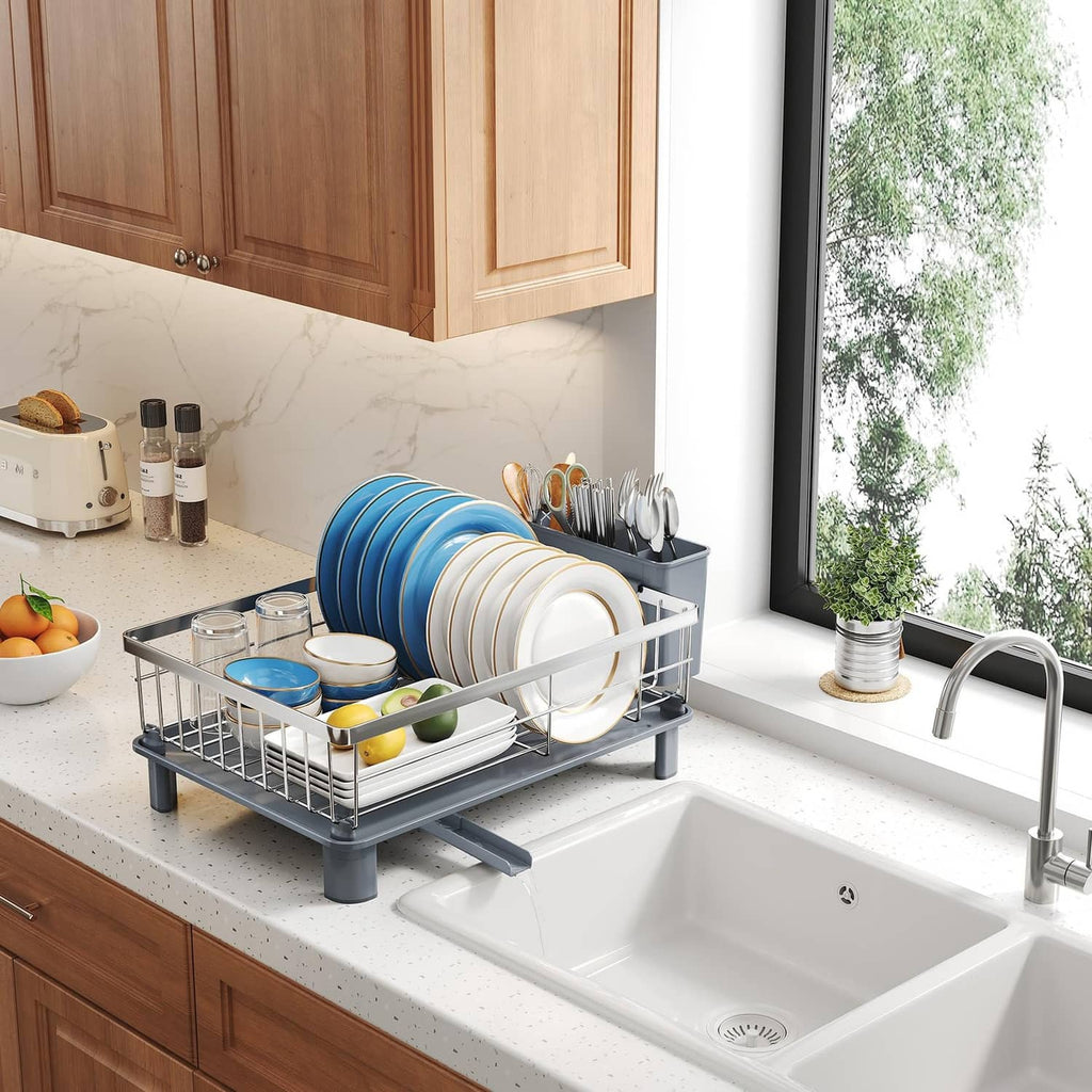 Compact silver dish drying rack with utensil holder beside the sink