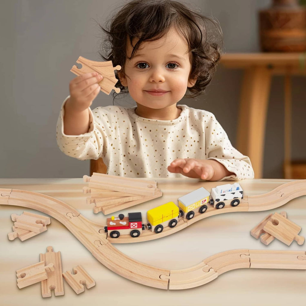 Wooden train track set with curved and straight rails; child holds a track piece.