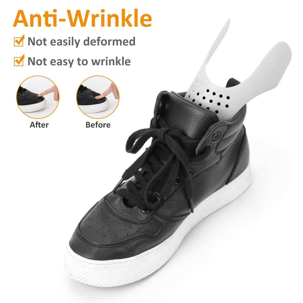 Black sneaker with vented shoe crease protector insert mounted over the toe area.