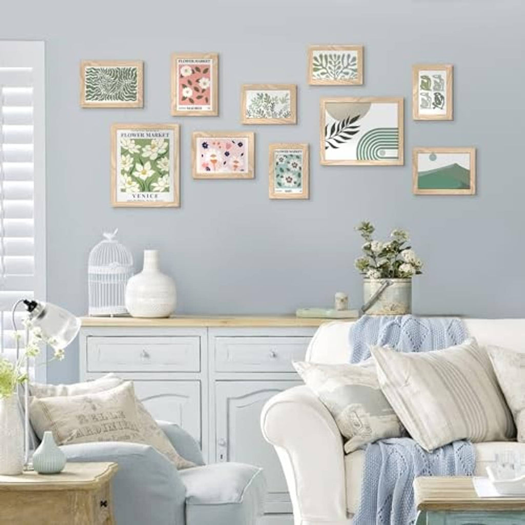 Natural wood picture frame set with floral prints, displayed on wall above seating