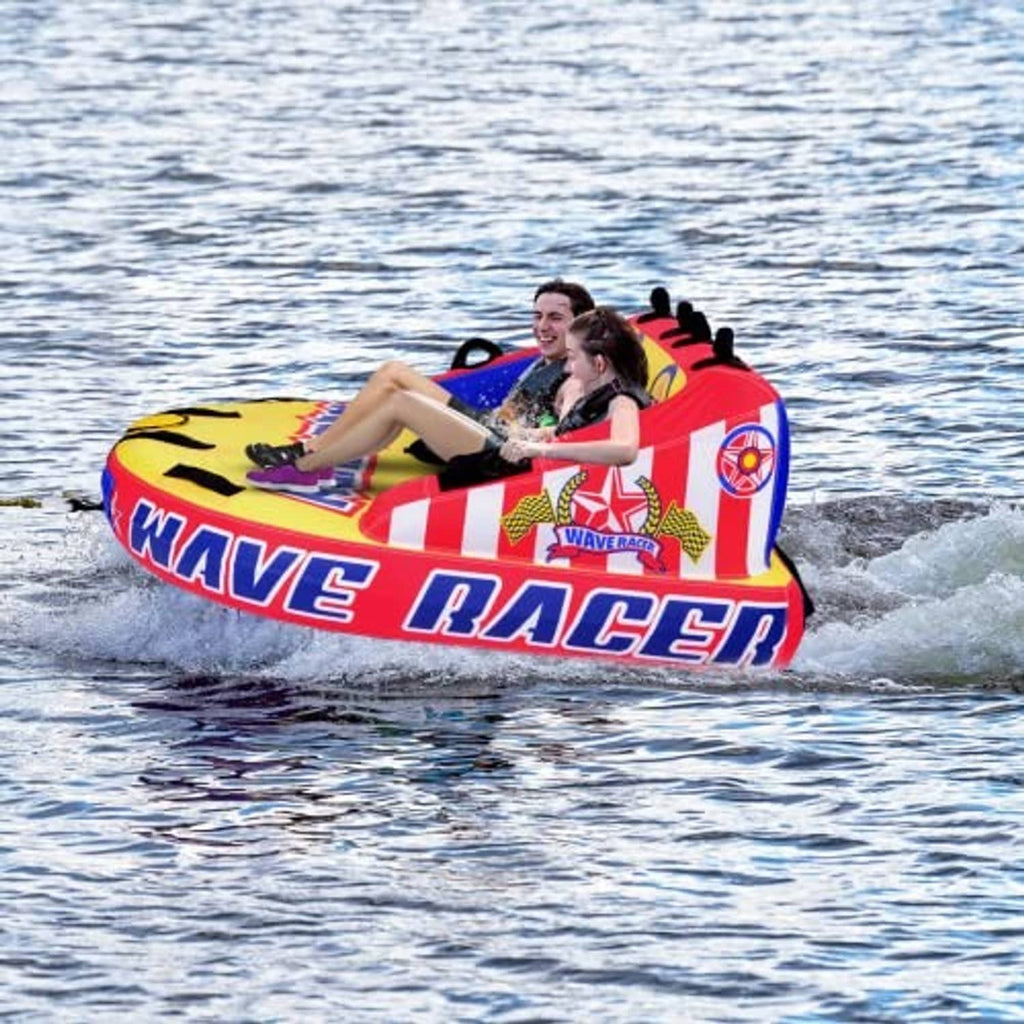 Inflatable wave-racer tow tube with two riders, red and blue body, black handles and backrest