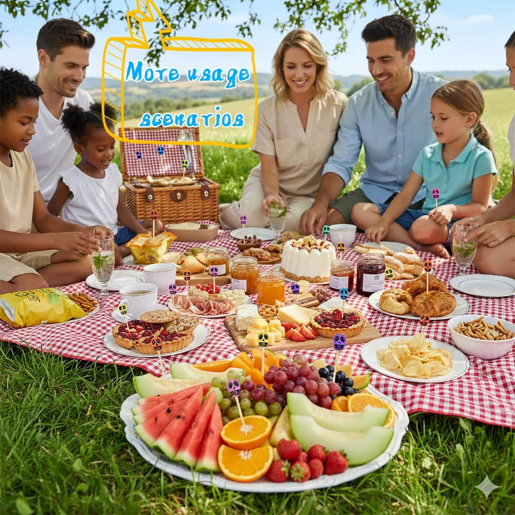 Skull-topped bamboo toothpicks on a picnic spread with fruits and snacks