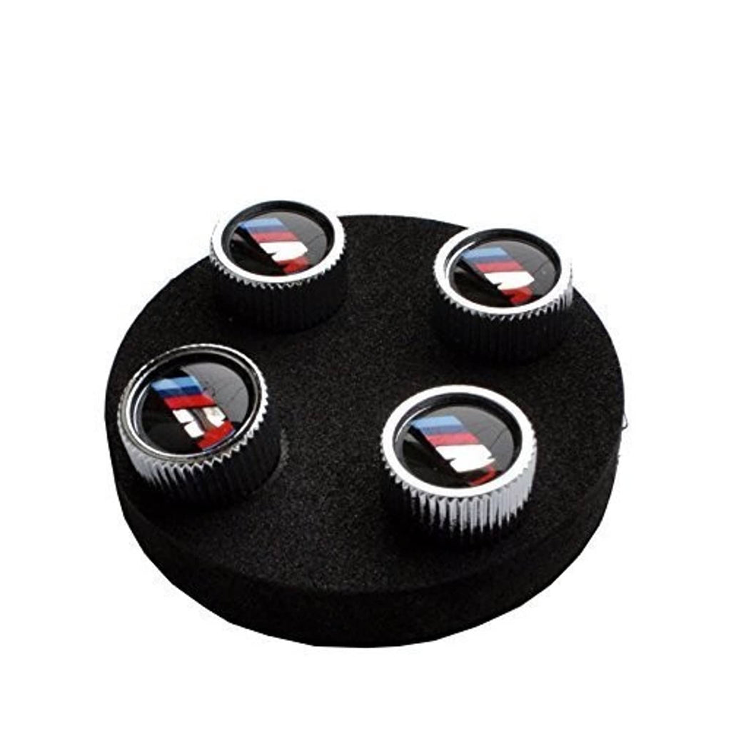 Set of 4 BMW M logo tire valve stem caps on black foam insert