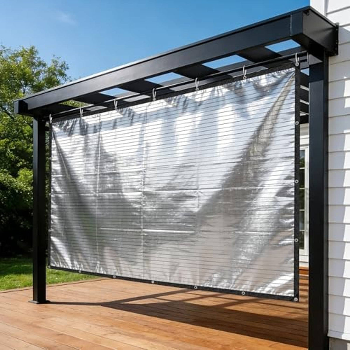 Large silver reflective tarp on outdoor pergola, black border with grommets