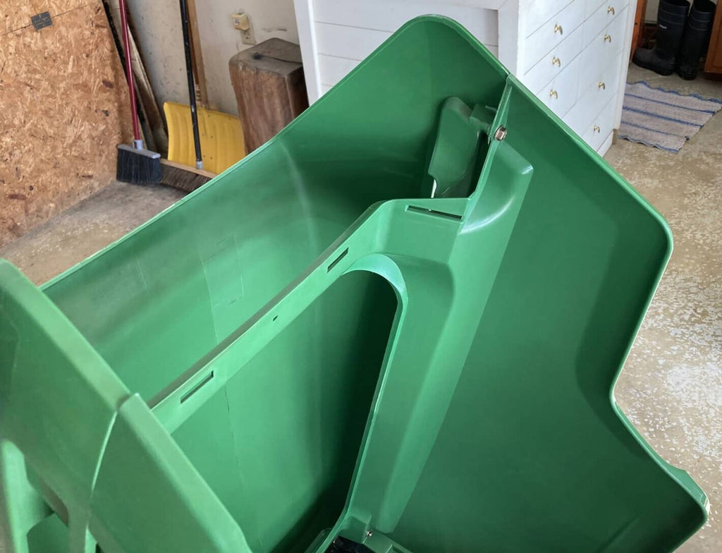 Green mower hood interior panel with raised rim and central opening
