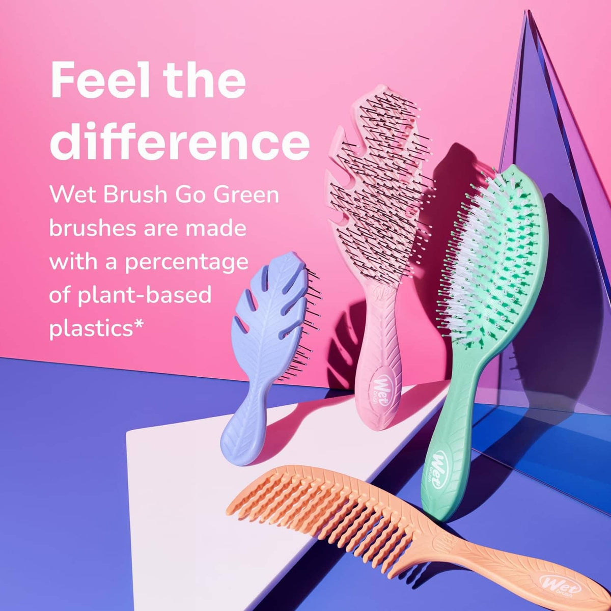 Go Green curl detangler brushes with plant-based plastic, shown in pink and green