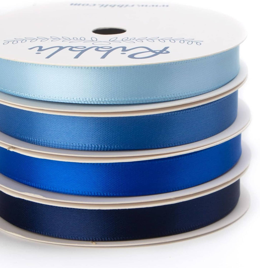 Stacked 3/8 inch satin ribbon on white spools in light blue, royal blue, and navy
