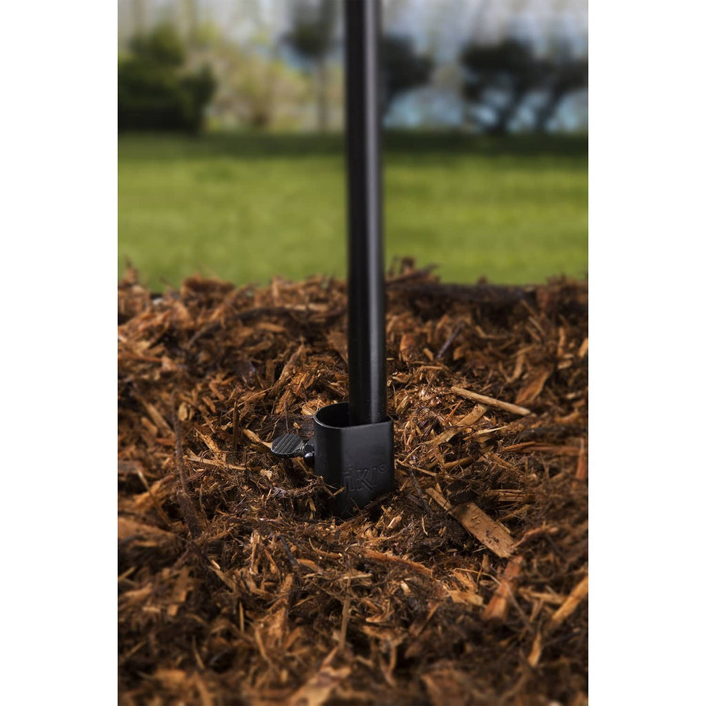 Close-up of black torch stake base with grip ring on mulch