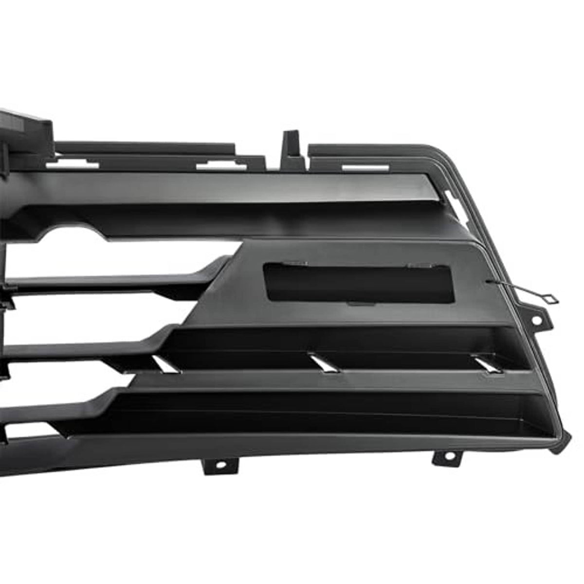 Close-up of black grille housing with vent openings and mounting tabs