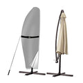 Gray cantilever patio umbrella cover with black strap securing the fabric.