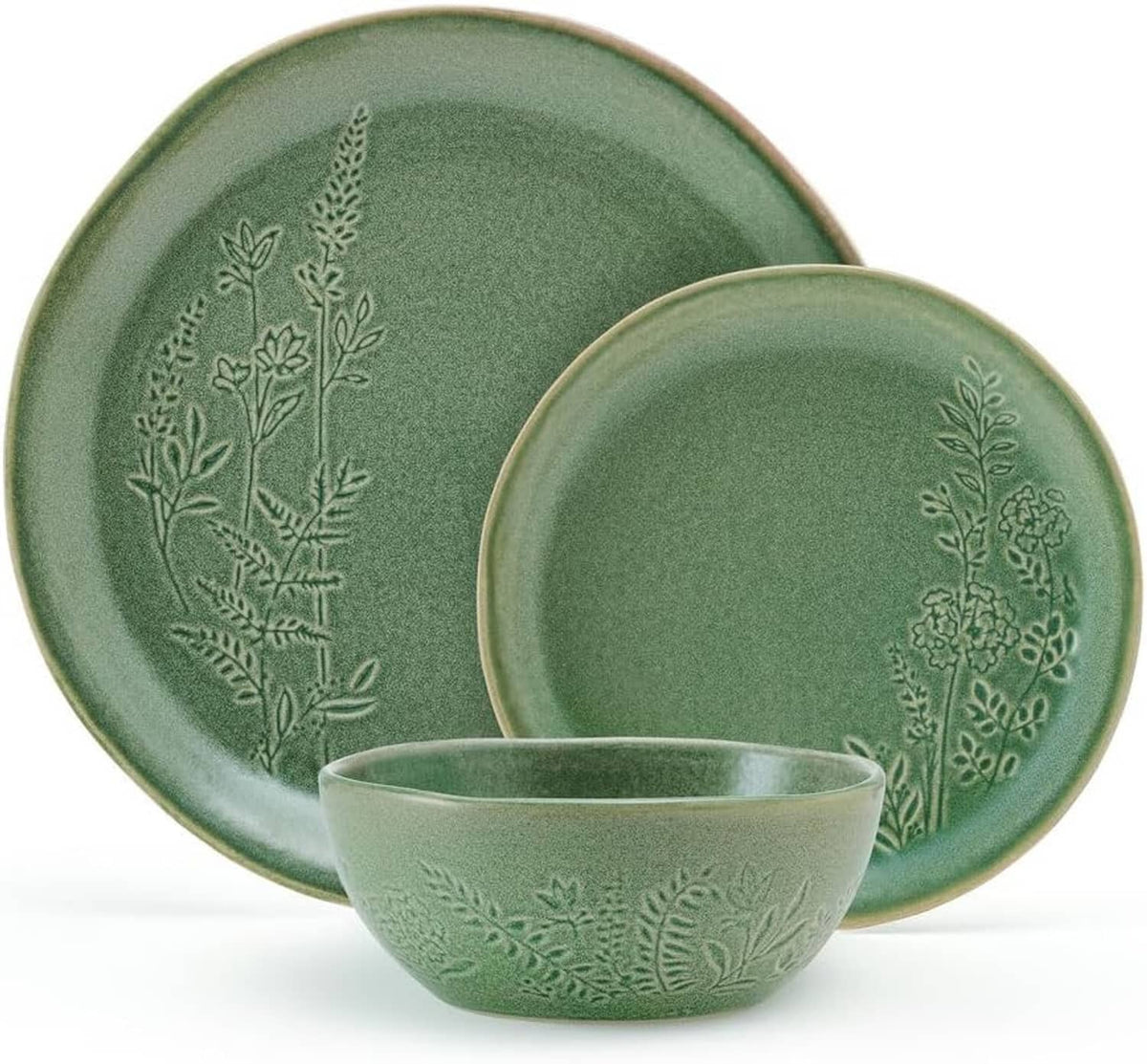 Stacked green dinner plates with embossed botanical motif and matching serving bowl