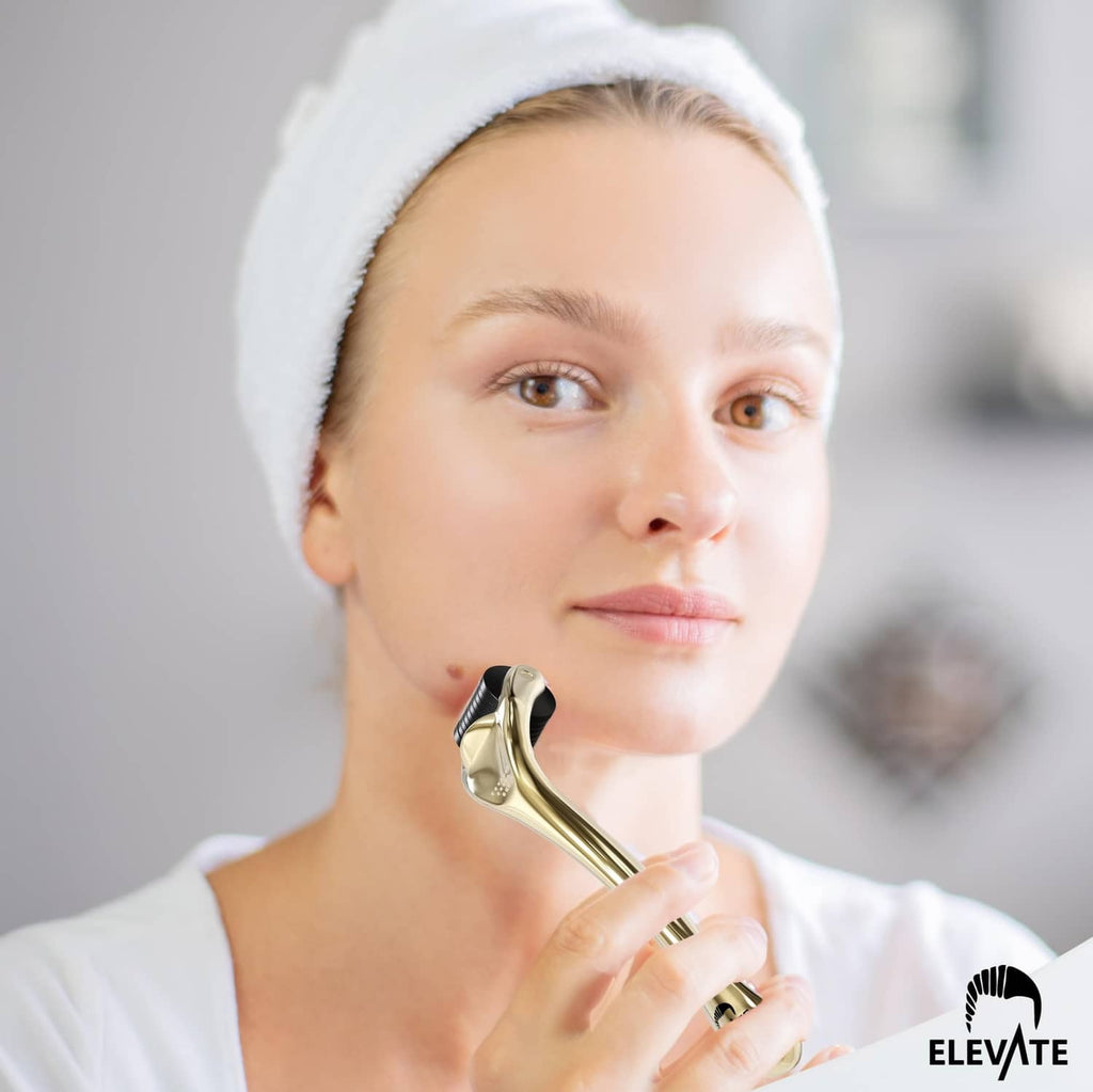 Gold microneedle derma roller held at cheek for facial treatment